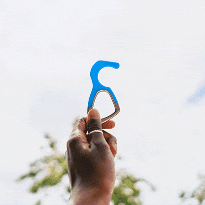 Patented antimicrobial silicone no-touch keychain tool on wooden surface with keys and packaging box